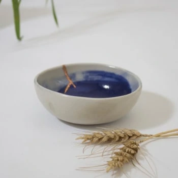 white and blue ceramic bowl with kintsugi